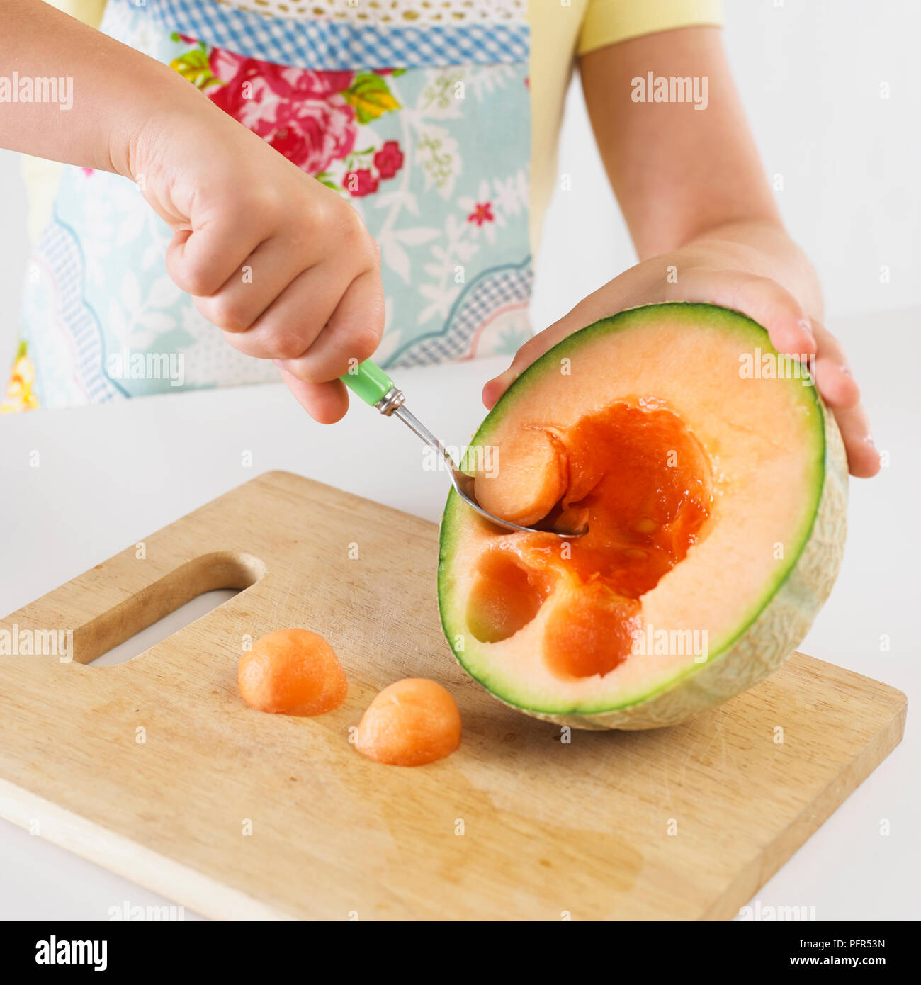 Girl balling a melon Stock Photo