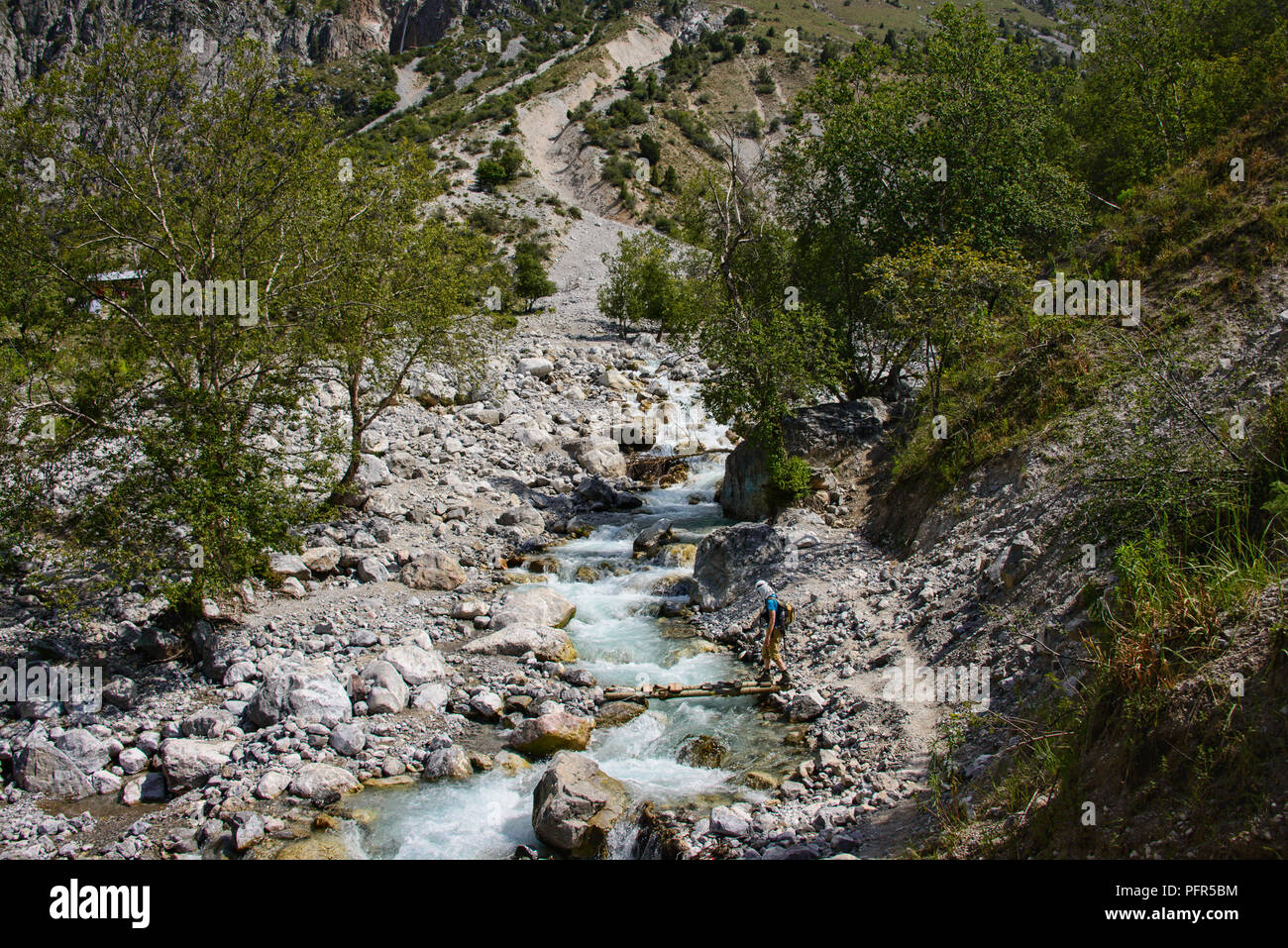 River crossing while trekking from the walnut village of Arslanbob, Kyrgyzstan Stock Photo