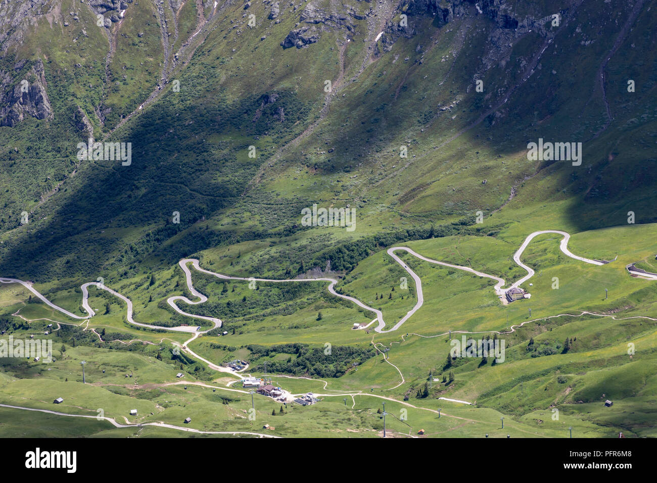 snaking mountain road crossing the pass of pordoi in the italian dolomites Stock Photo