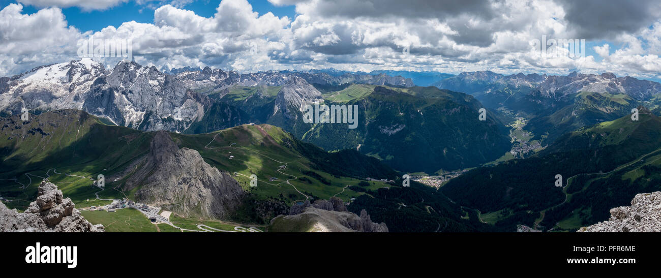 panoramic view looking down into the pass of pordoi in the italian dolomites towards canazei and campitello Stock Photo