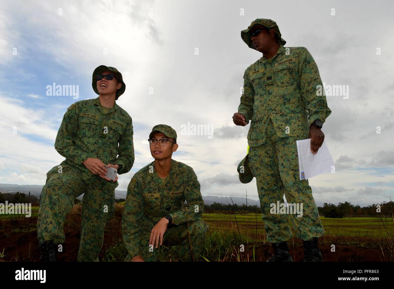 Singapore Army Soldiers review the terrain of the Battle Area Complex  during a Tiger Balm 18 terrain walk at Schofield Barracks, Hawaii, on May 21,  2018. Tiger Balm is a bilateral exercise