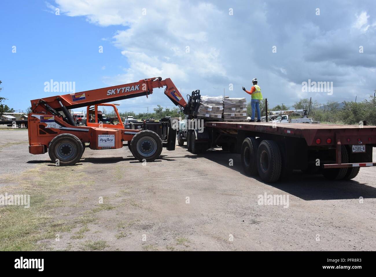 PONCE, Puerto Rico –  Materials from the power grid restoration mission are loaded onto a truck at Fort Allen, Puerto Rico, May 22. The material is being transferred to the laydown yard in Ponce, Puerto Rico, to be inventoried. Any materiel not allocated to PREPA will be considered excess and will be transferred to FEMA for final disposition.USACE logisticians continue supporting Hurricane Maria recovery efforts by maintaining supply chains at the port. FEMA mission assigned USACE the central responsibility for purchase and distribution of all Bill of Materiel (BOM) supplies needed for the gri Stock Photo