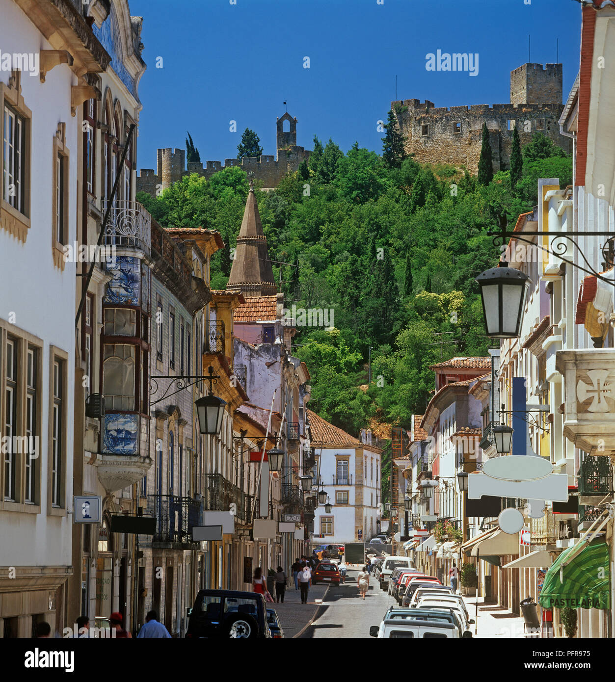 Portugal, Tomar, Rua Serpa Pinto, street overlooked by old castle Stock Photo