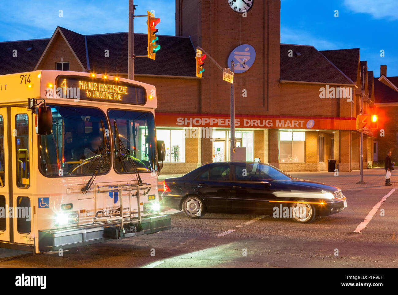 A York Region Transit (YRT) bus along Major Mackenzie Drive West in downtown at dusk. Vaughan
