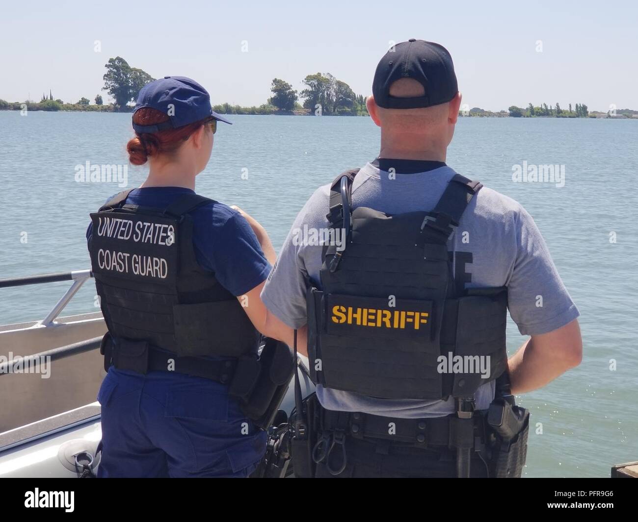 Petty Officer 3rd Class Iris Bahr of Coast Guard Station Rio Vista and Mike Keegan of the Sacramento County Sheriff’s Marine Unit watch over the Delta Waterway in Rio Vista, California, May 22, 2018 during National Safe Boating Week.  The Coast Guard works closely with local law enforcement agencies to collaboratively patrol waterways and promote boating safety.  (Coast Guard Stock Photo