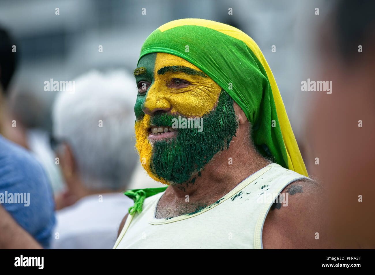 Rio de Janeiro – December 4, 2016: A Brazil protester, his face painted with the national colors, takes part in a demonstration against corruption Stock Photo