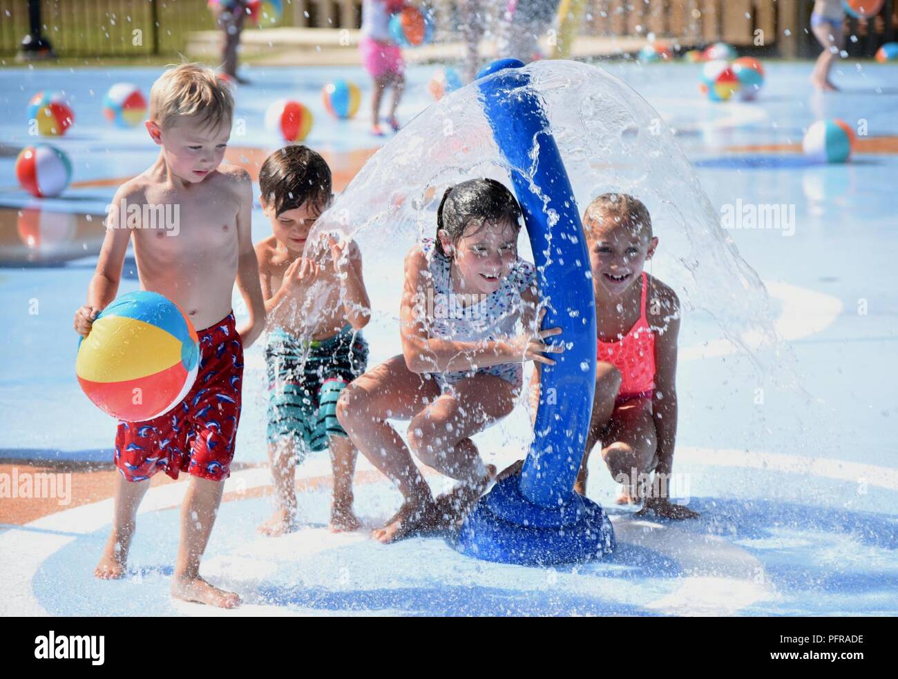 Military children play on the splash pad during the Splash Pad Ribbon
