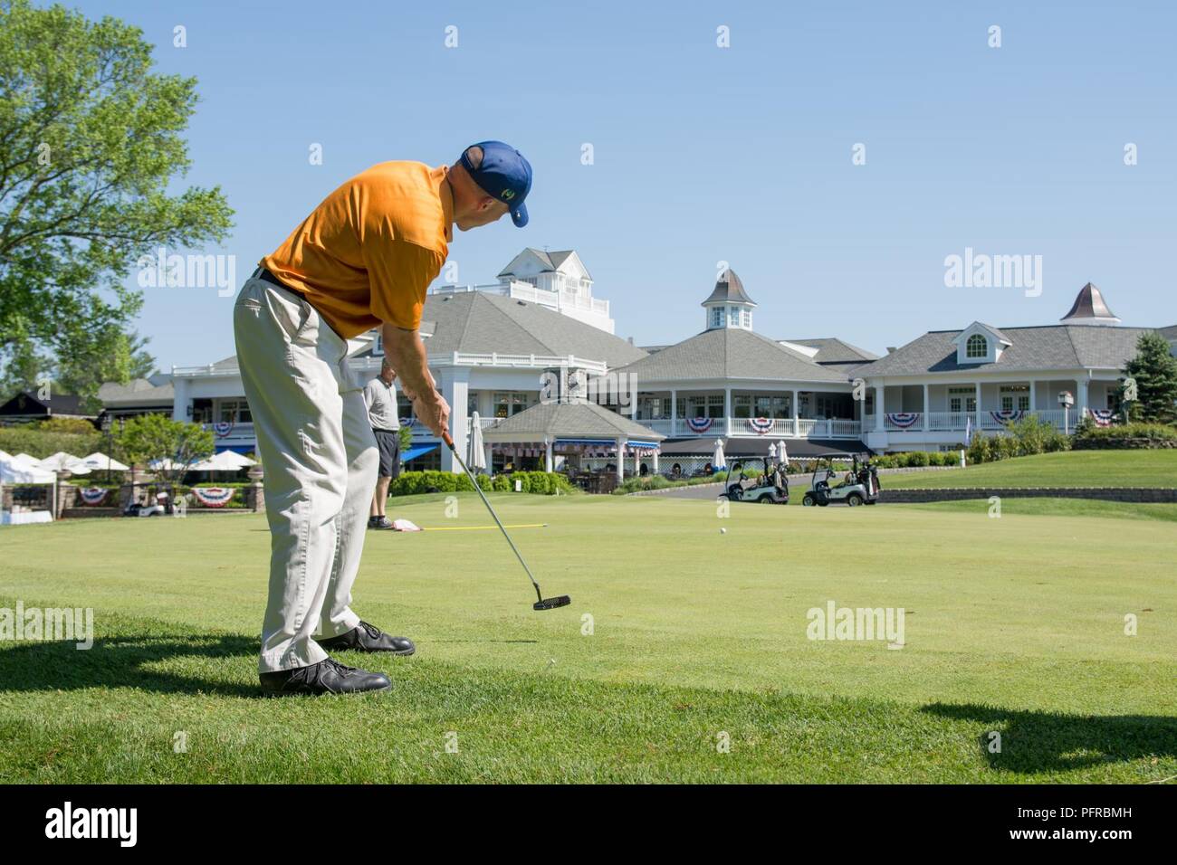 FARMINGDALE, N.J. (May 24, 2018) U.S. Marine Capt. Nathan McDonald putts on the green during the Honor Day 2018 Golf Tournament at Eagle Oaks Golf & Country Club, an event benefitting Hope For The Warriors, a non-profit organization, during the festivities of Fleet Week New York (FWNY). Now in its 30th year, FWNY is the city’s time-honored celebration of the sea services. It is an unparalleled opportunity for the citizens of New York and the surrounding tri-state area to meet Sailors, Marines and Coast Guardsmen, as well as witness firsthand the latest capabilities of today’s maritime services Stock Photo