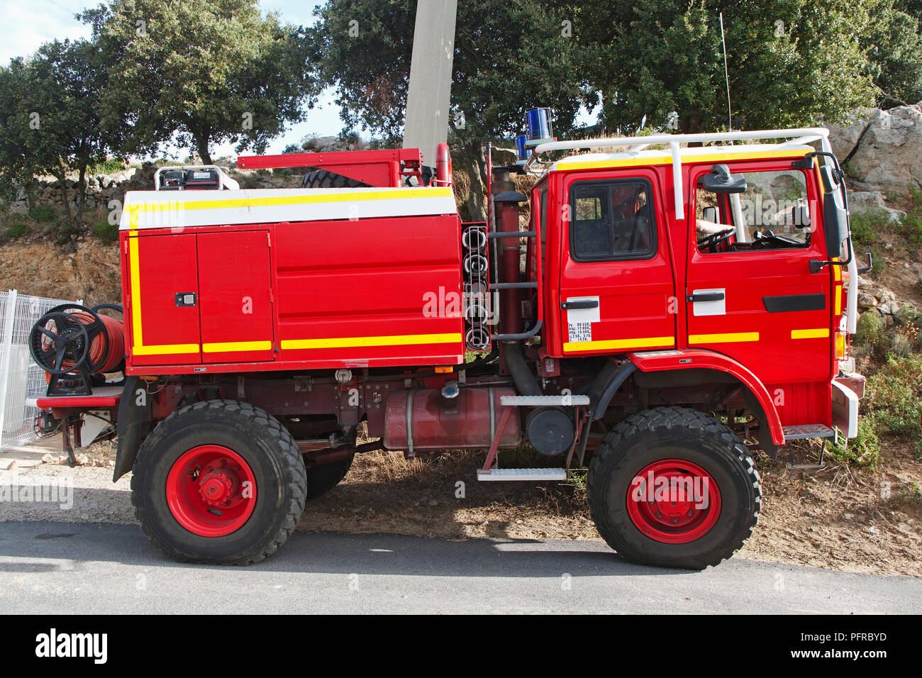 Corsica, red fire engine parked at side of road on island Stock Photo