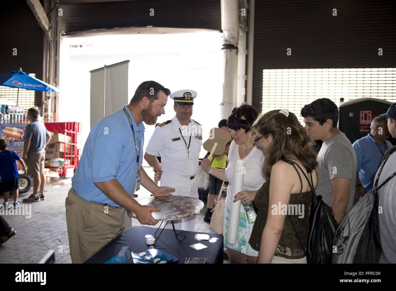 NEW YORK (May 26, 2018) Michael Jones, the environmental resources and planning section head for U.S. Fleet Forces Command’s Fleet Environmental and Readiness Division, explains the shipboard waste process to reduce plastic waste aboard ships at the U.S. Navy’s “Stewards of the Sea: Defending Freedom, Protecting the Environment” exhibit during Fleet Week New York. The Navy employs every means available to mitigate the potential environmental effects of our activities without jeopardizing the safety of our Sailors or impacting our Navy readiness mission. Stock Photo