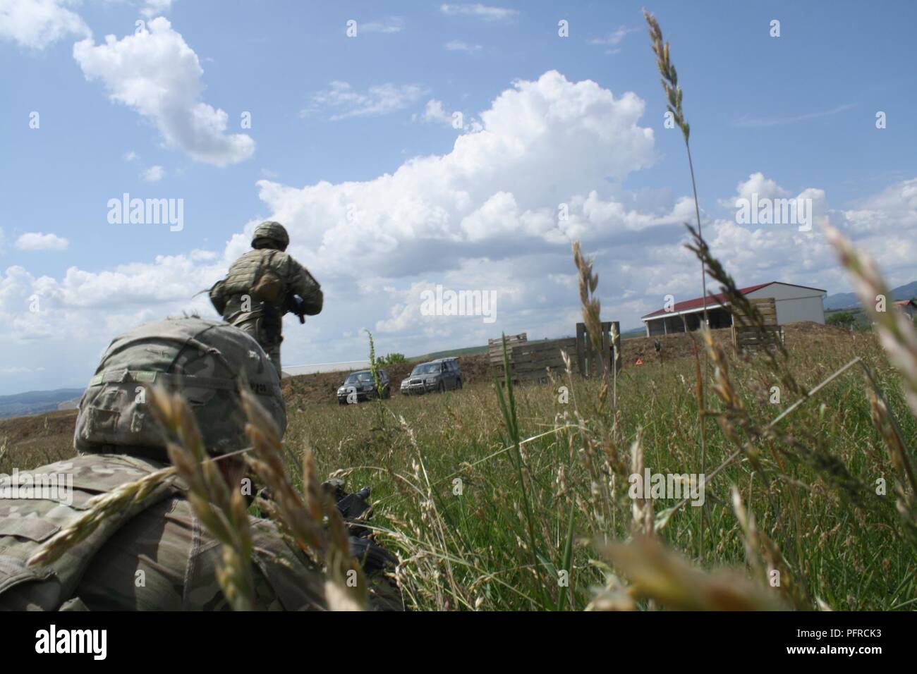 A Soldier bounds forward toward cover while another suppresses the enemy during Advanced Rifle Marksmanship and Individual Movement Techniques training May 24 at Camp Marechal De Lattre De Tassigny, Kosovo. Stock Photo