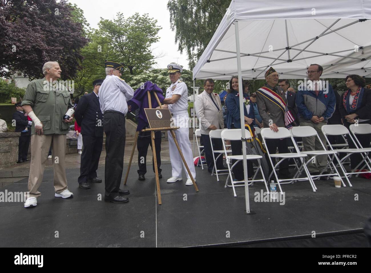 NEW YORK (May 27, 2018) Vice Adm. Dixon Smith, Deputy Chief of Naval Operations, Fleet Readiness and Logistics, and Richard Pecci, the commander of American Legion on Hasting Admiral Farragut post unveil the plaque certifying Hasting-on-Hudson as a Purple Heart village during the annual Hudson-on-Hasting Memorial Day parade during Fleet Week New York (FWNY). Now in its 30th year, FWNY is the city’s time-honored celebration of the sea services. It is an unparalleled opportunity for the citizens of New York and the surrounding tri-state area to meet Sailors, Marines and Coast Guardsmen, as well  Stock Photo