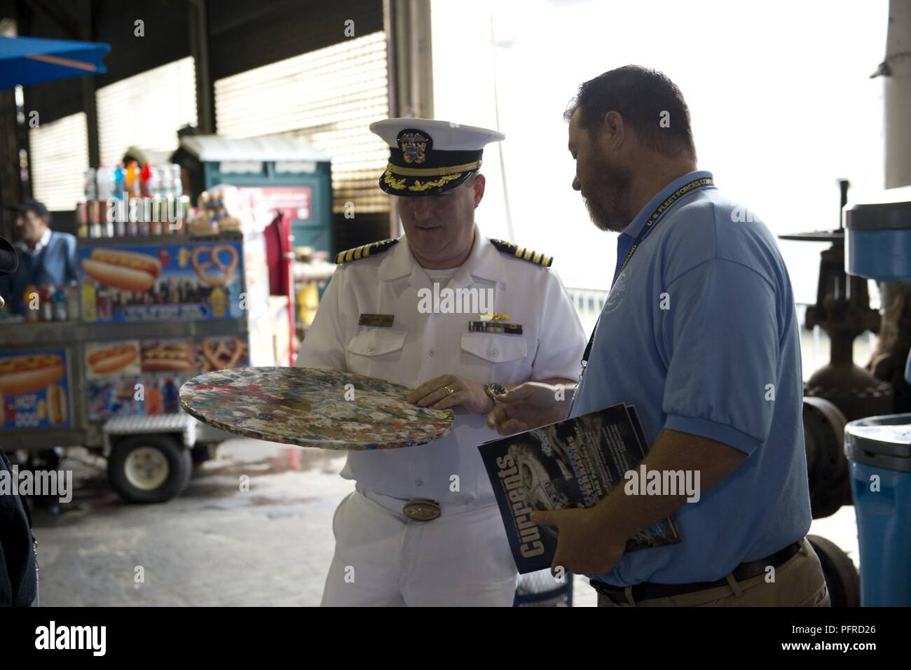 NEW YORK (May 27, 2018) Michael Jones, the environmental resources and planning section head for U.S. Fleet Forces Command’s Fleet Environmental and Readiness Division, explains the shipboard waste process to reduce plastic waste aboard ships at the U.S. Navy’s “Stewards of the Sea: Defending Freedom, Protecting the Environment” exhibit during Fleet Week New York. The Navy employs every means available to mitigate the potential environmental effects of our activities without jeopardizing the safety of our Sailors or impacting our Navy readiness mission. Stock Photo