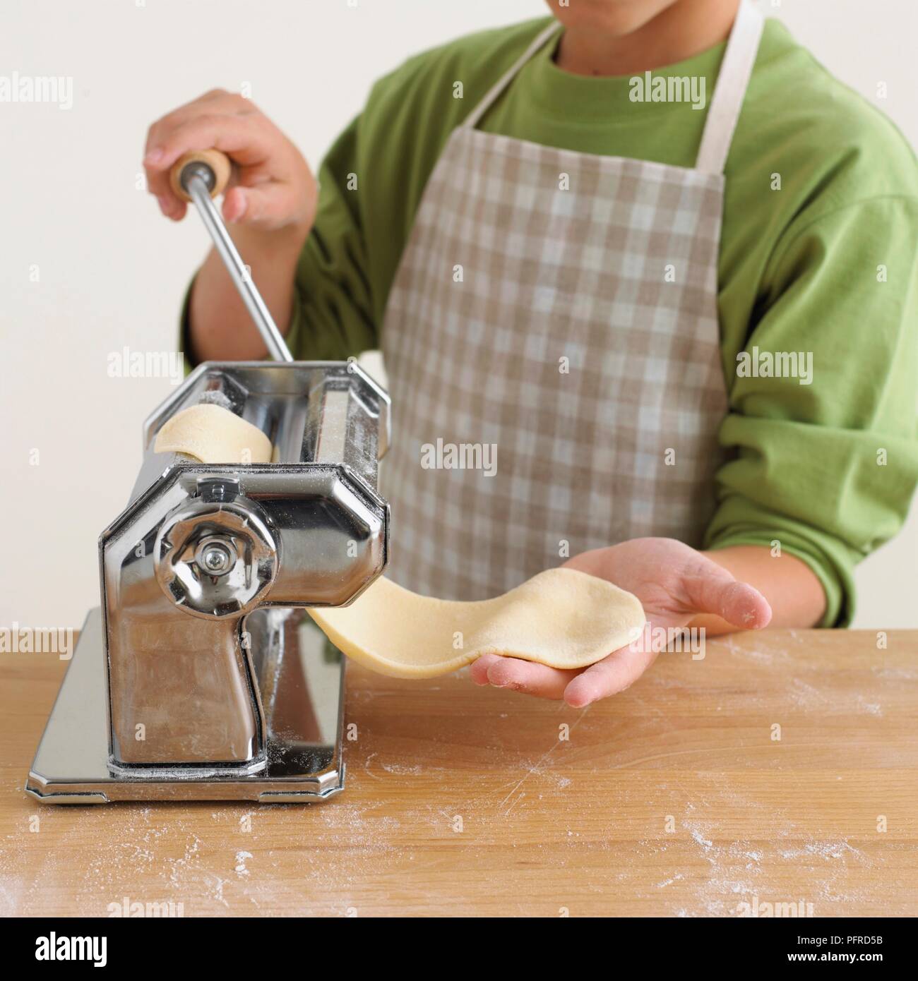 Boy using pasta machine Stock Photo - Alamy