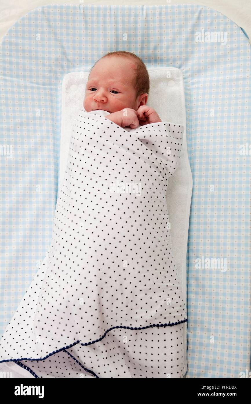 Baby boy wrapped in blanket, overhead view Stock Photo