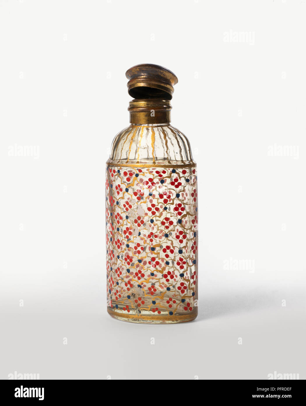 Intricately decorated old fashioned perfume bottle with open gold lid Stock Photo