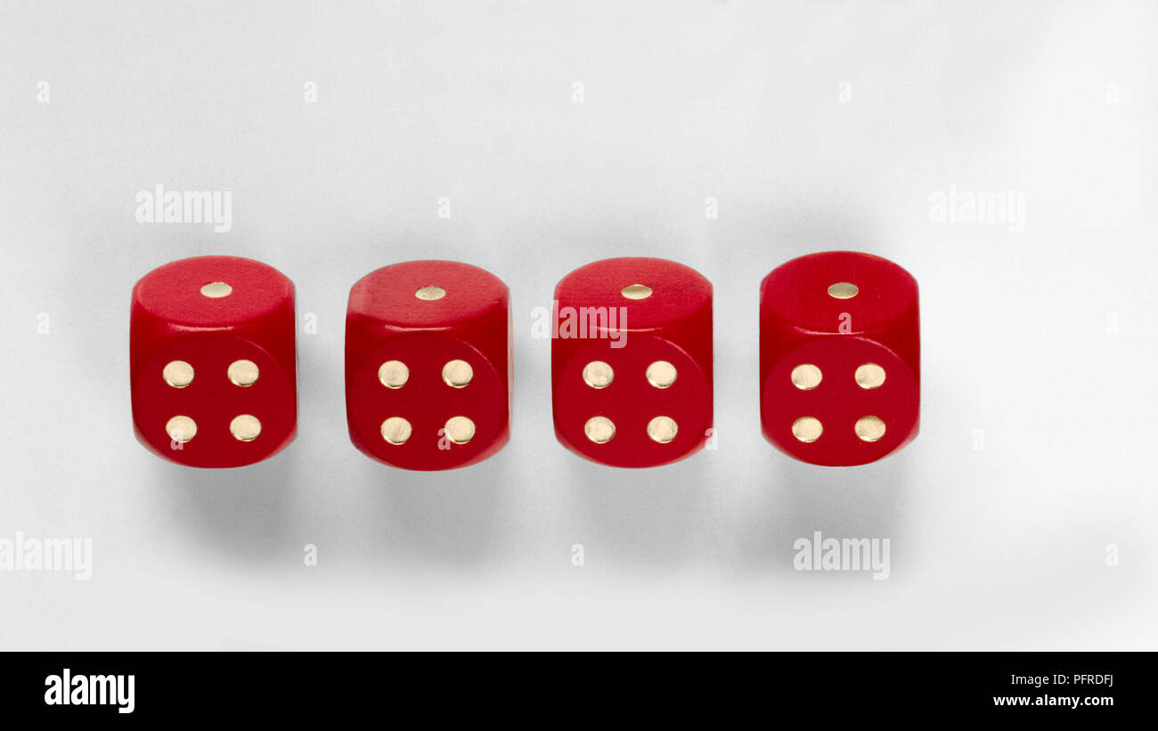 Four red dice showing the same number of dots on each face Stock Photo