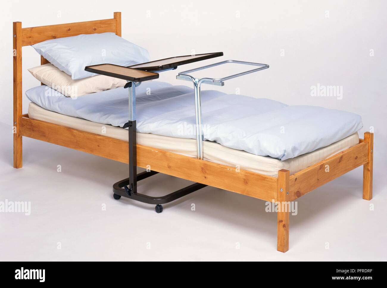 Adjustable bed table, bed blanket raiser and bed Stock Photo