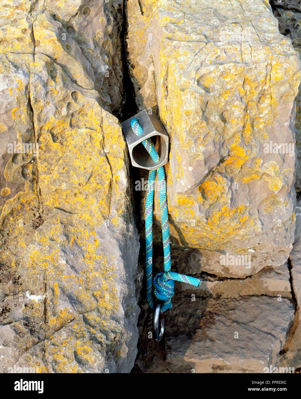 Large hex with rope in rock crevice, close-up Stock Photo