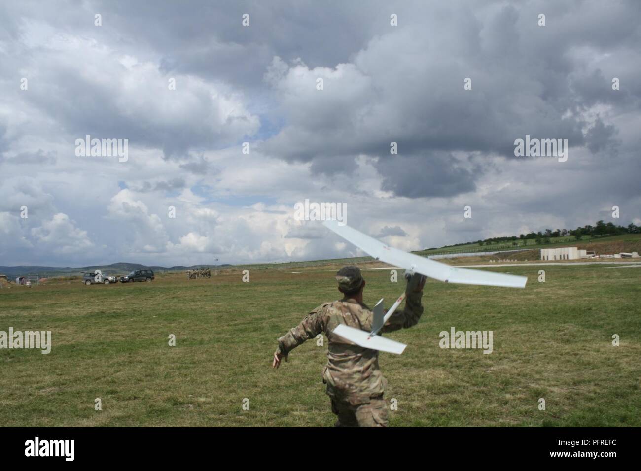 A Soldier from the 3-61 CAV launces an RQ-11 Raven during Raven Initial Qualification Training May 24 at Camp Marechal De Lattre De Tassigny, Kosovo. Stock Photo