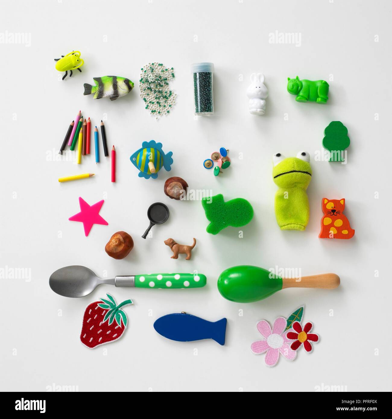 Large group of small toys, spoon, glitter, pencils, beads and conkers Stock Photo