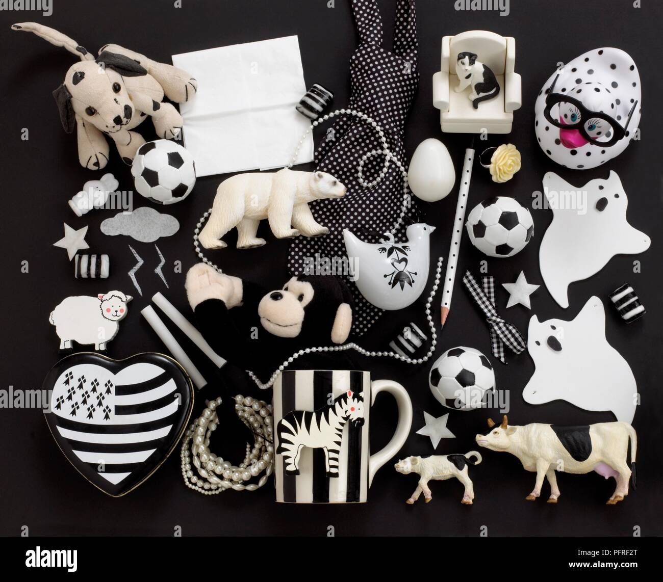 Small black and white toys on black background Stock Photo
