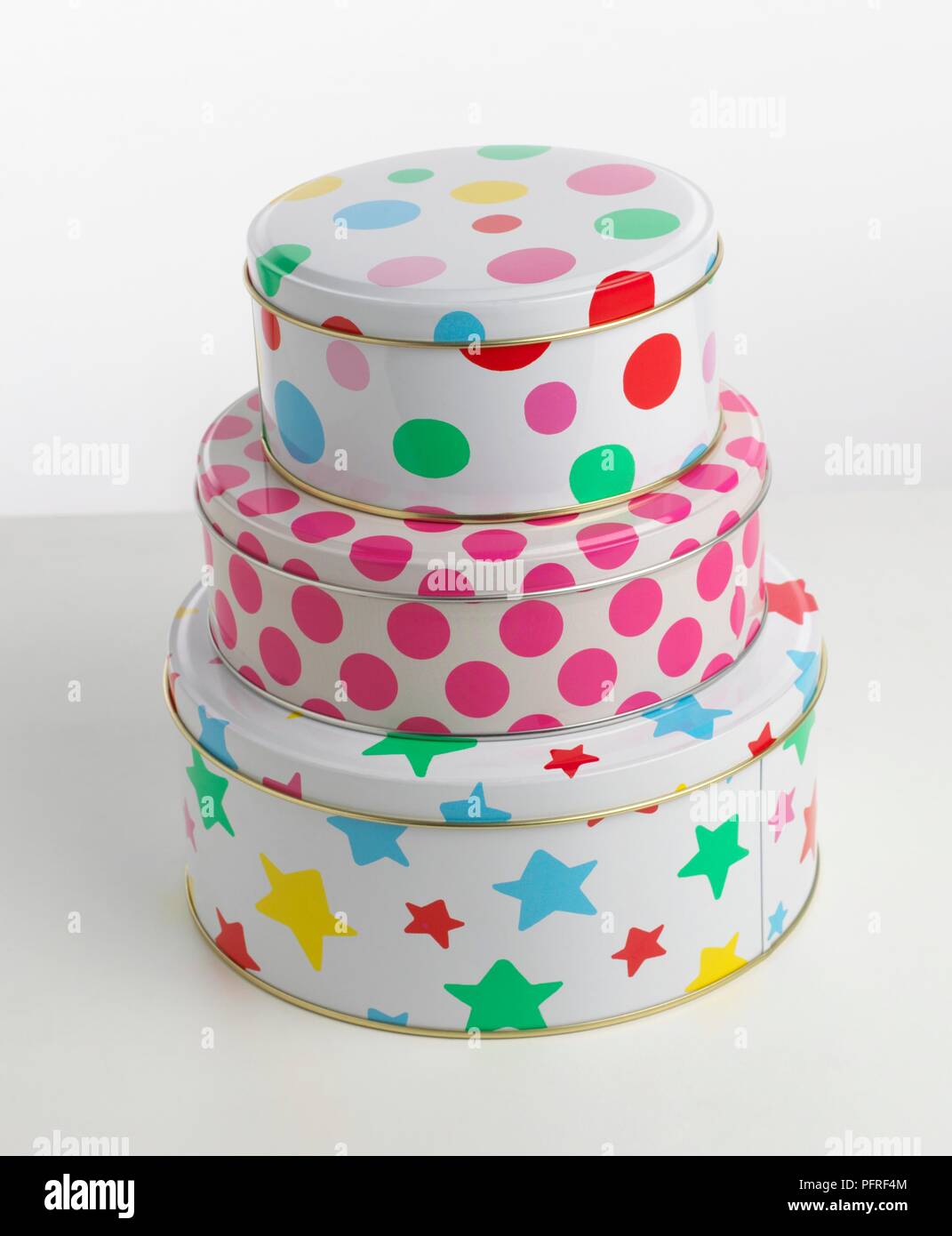 Stack of round tins decorated with stars and polka dots Stock Photo