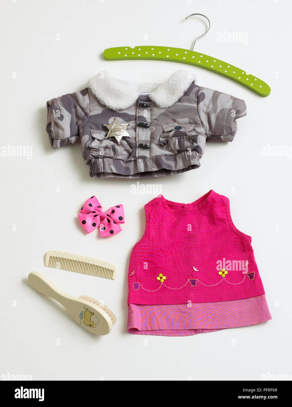 Baby clothing including dress, jacket, coat hanger and personal accessories Stock Photo