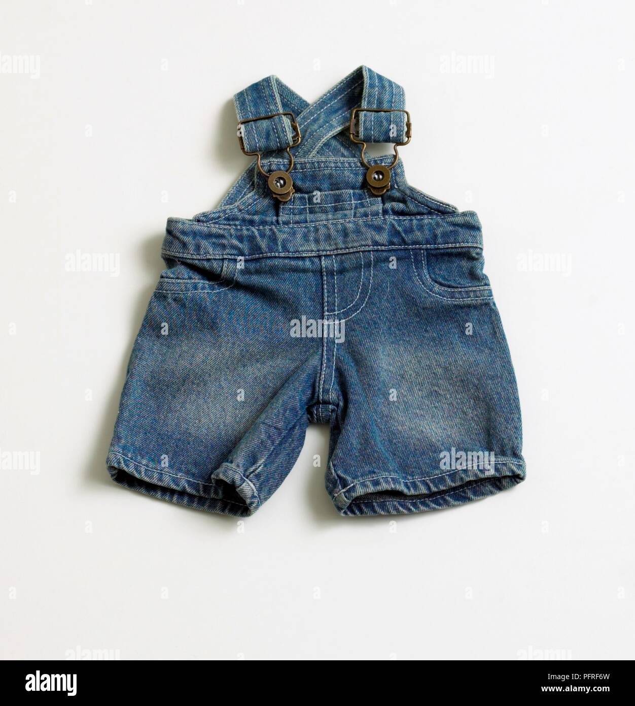 Baby's faded denim dungarees Stock Photo