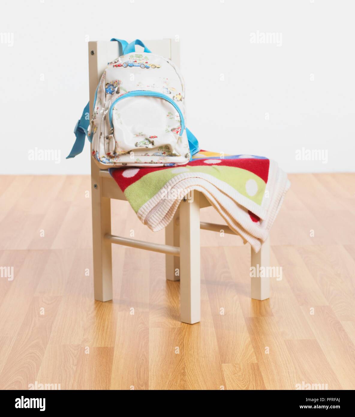 Rucksack and folded blanket on a chair Stock Photo
