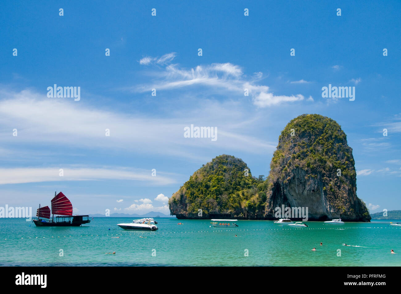 Thailand, Krabi, Hat Tham Phra Nang, view of rocks and junk ship, and various other boats Stock Photo