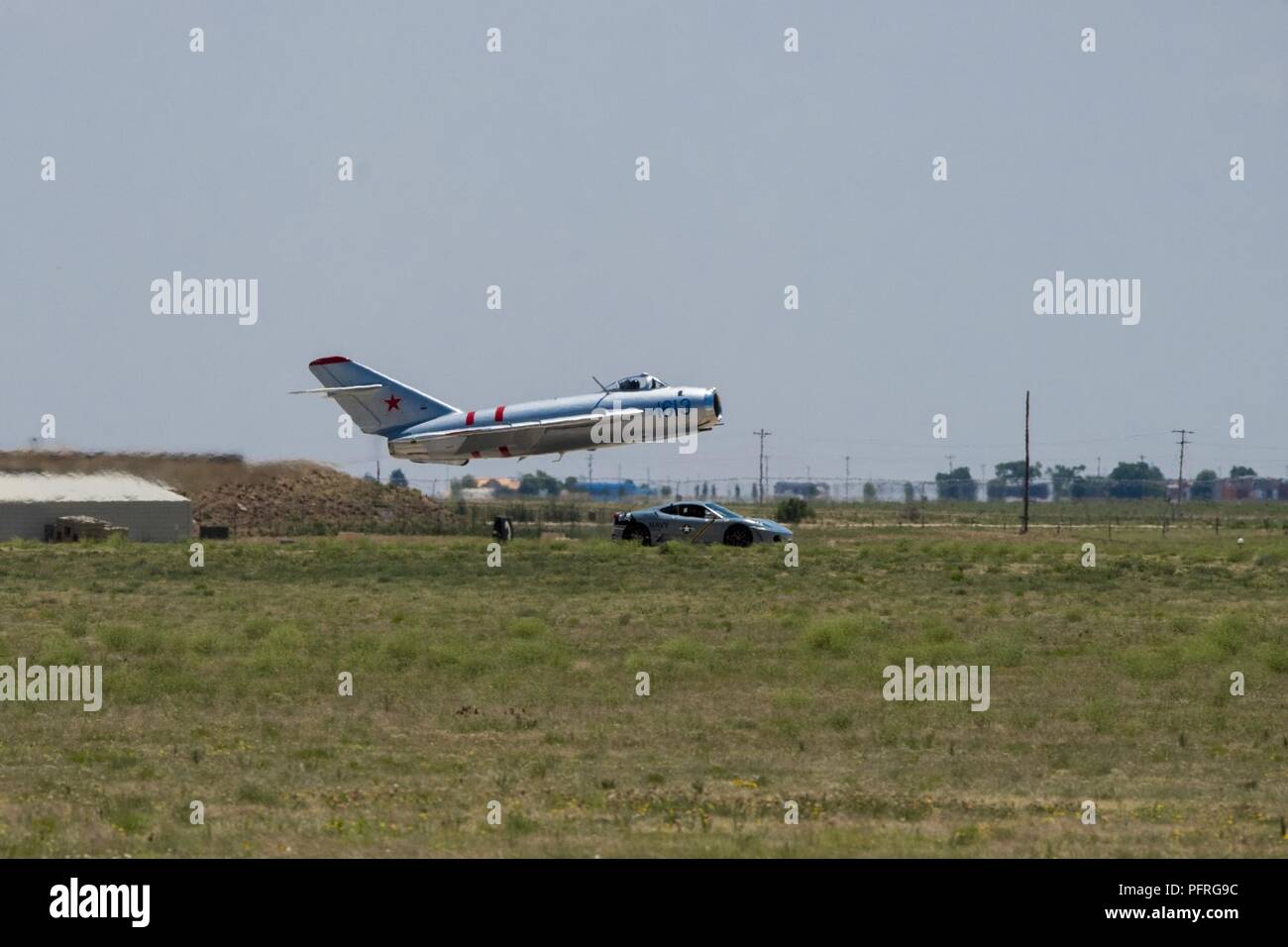 A MiG17 aircraft races a Ferrari during the Cannon Air Force Base Air