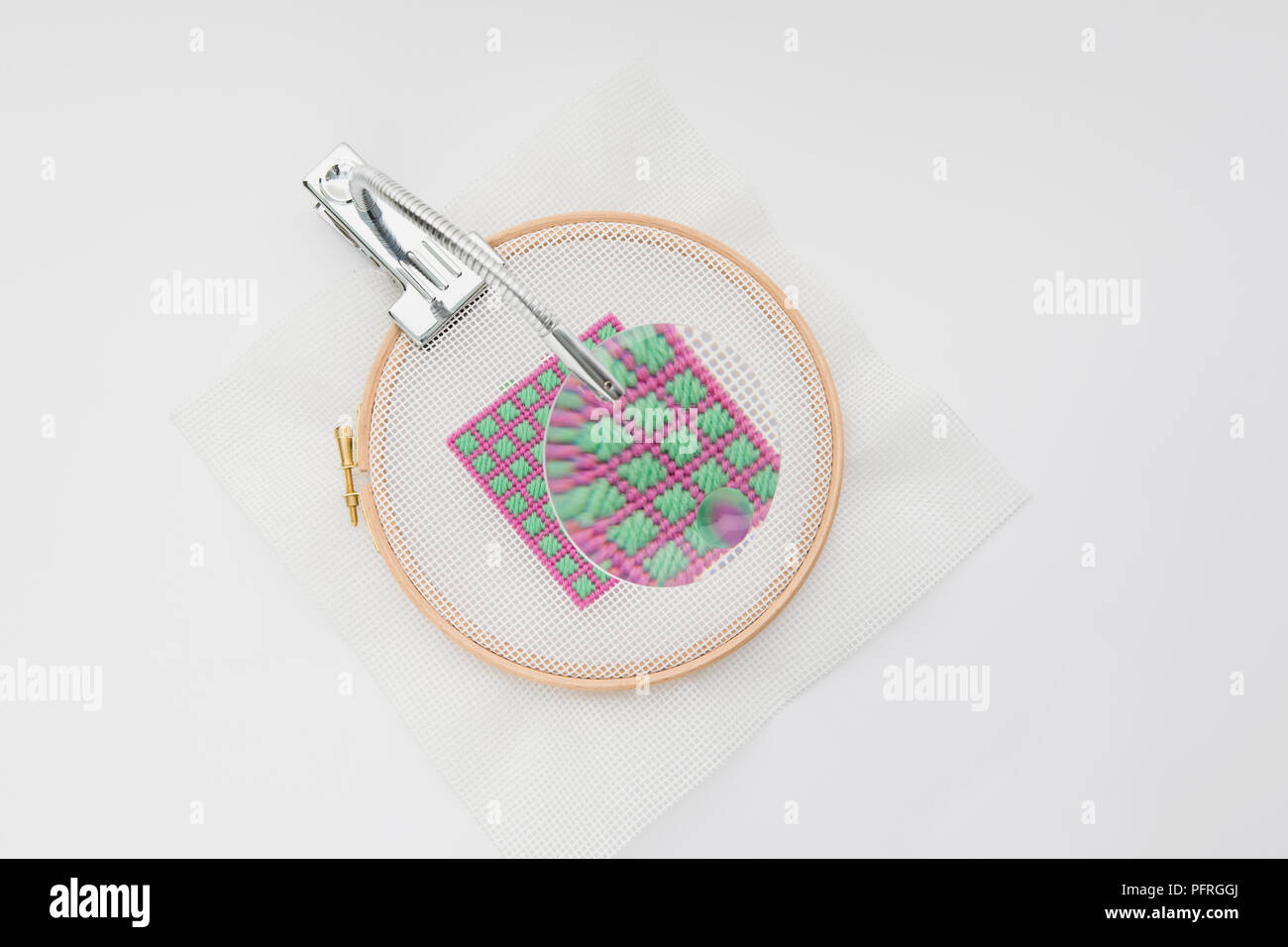Magnifier attached to piece of needlepoint work Stock Photo