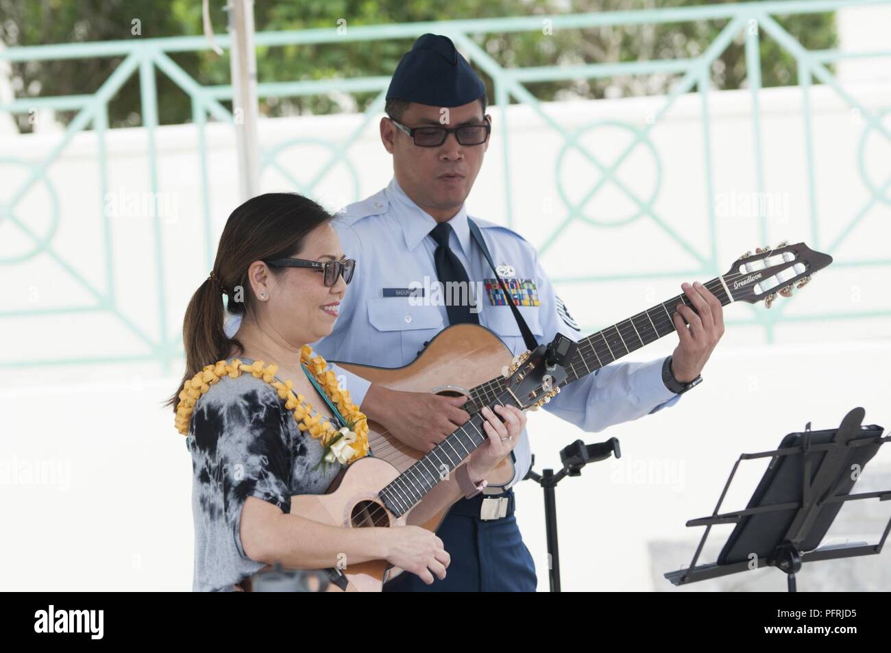 KANEOHE — Tech. Sgt. Daniel Baduria and his spouse, Nelly, perform “I’ll Remember You” during the 2018 Governor’s Memorial Day Ceremony at Hawaii State Veterans Cemetery, May 28, 2018. Stock Photo