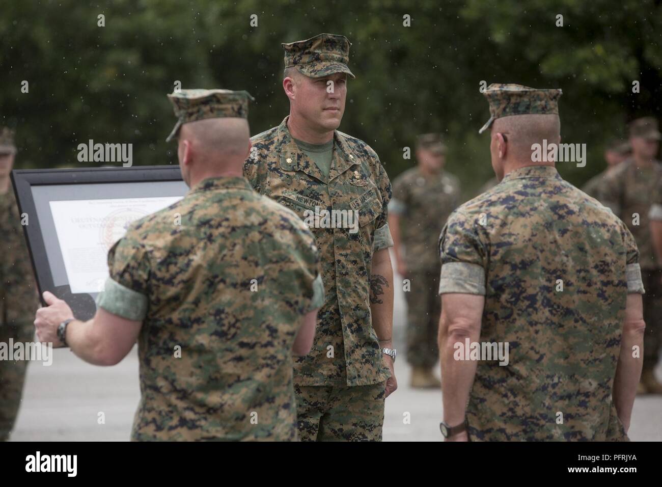 U.S. Marine Corps Maj. Geoffrey Newton, center, the commanding officer ...