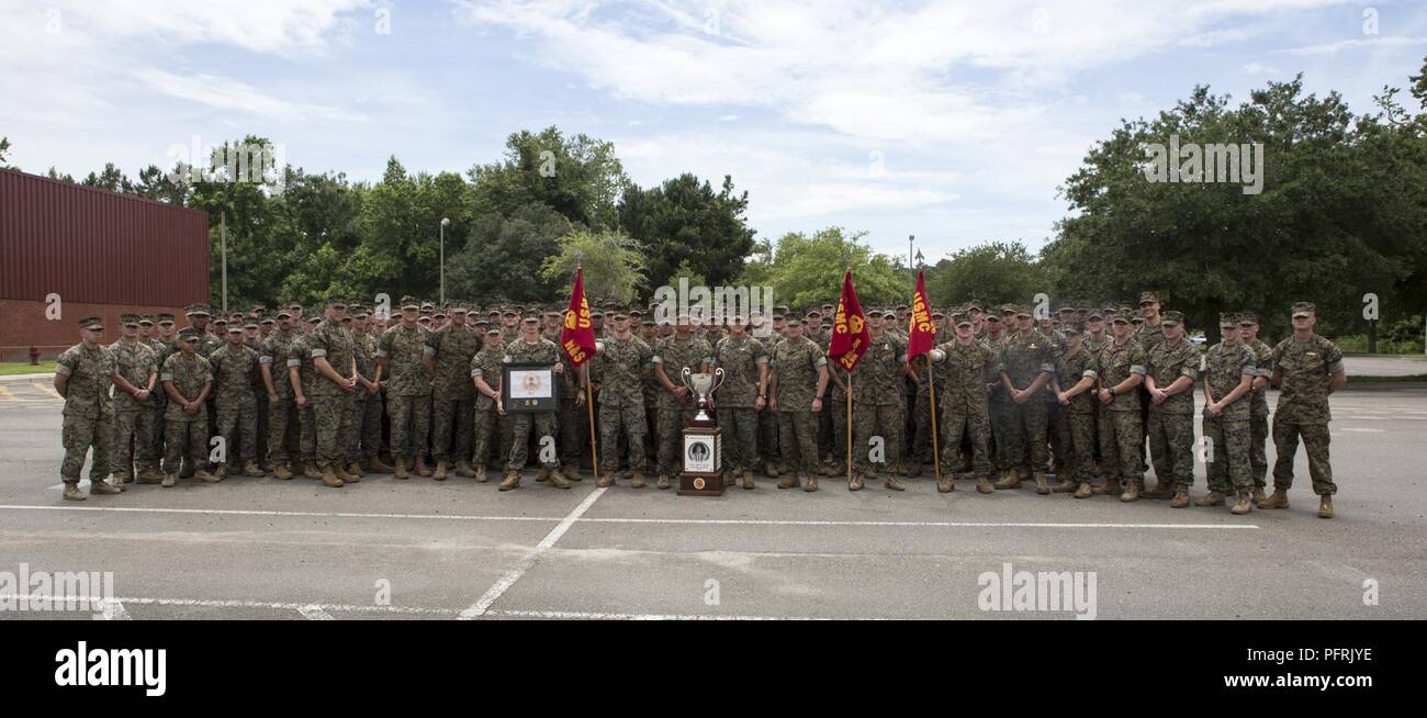 U.S. Marines and Sailors with 2nd Reconnaissance Battalion, 2nd Marine Division, pose for a photo with the Lt. Gen. Chesty Puller Outstanding Leadership Award at Camp Lejeune, N.C., May 30, 2018. 2nd Recon Bn. was recognized for exceptional professional ability, superior performance and outstanding dedication to supporting the mission of II MEF. Stock Photo