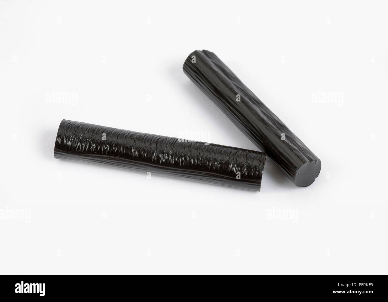 Two sticks of black liquorice extract Stock Photo Alamy