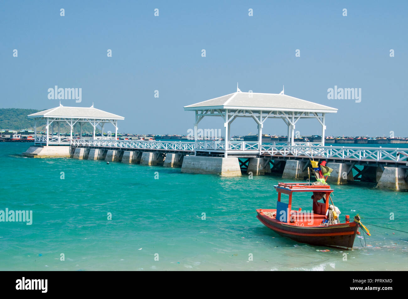 Thailand, Ko Sichang, Rama V's Palace, pier, and boat moored at water's edge Stock Photo