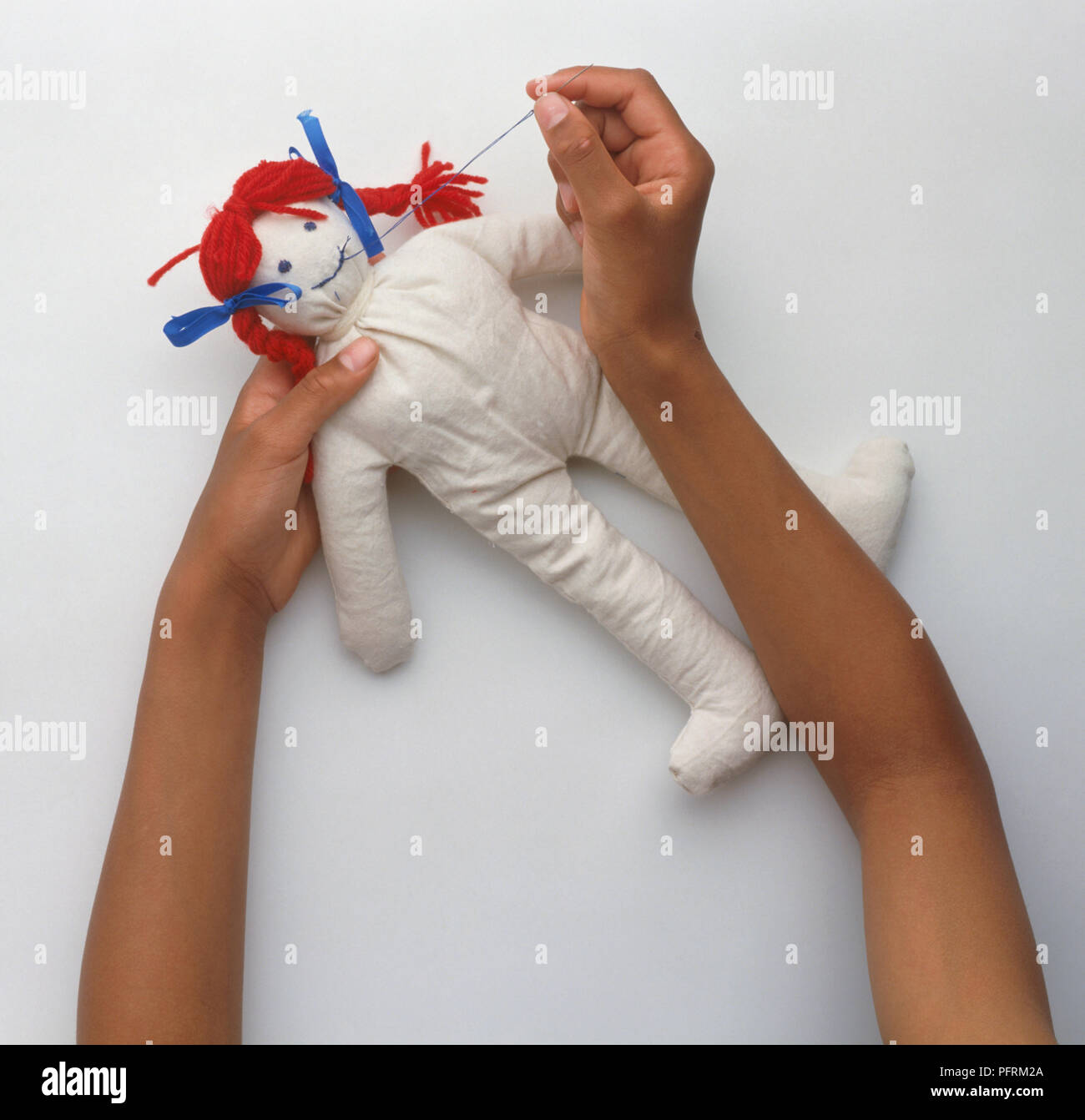 Sewing mouth on a rag doll's face Stock Photo - Alamy