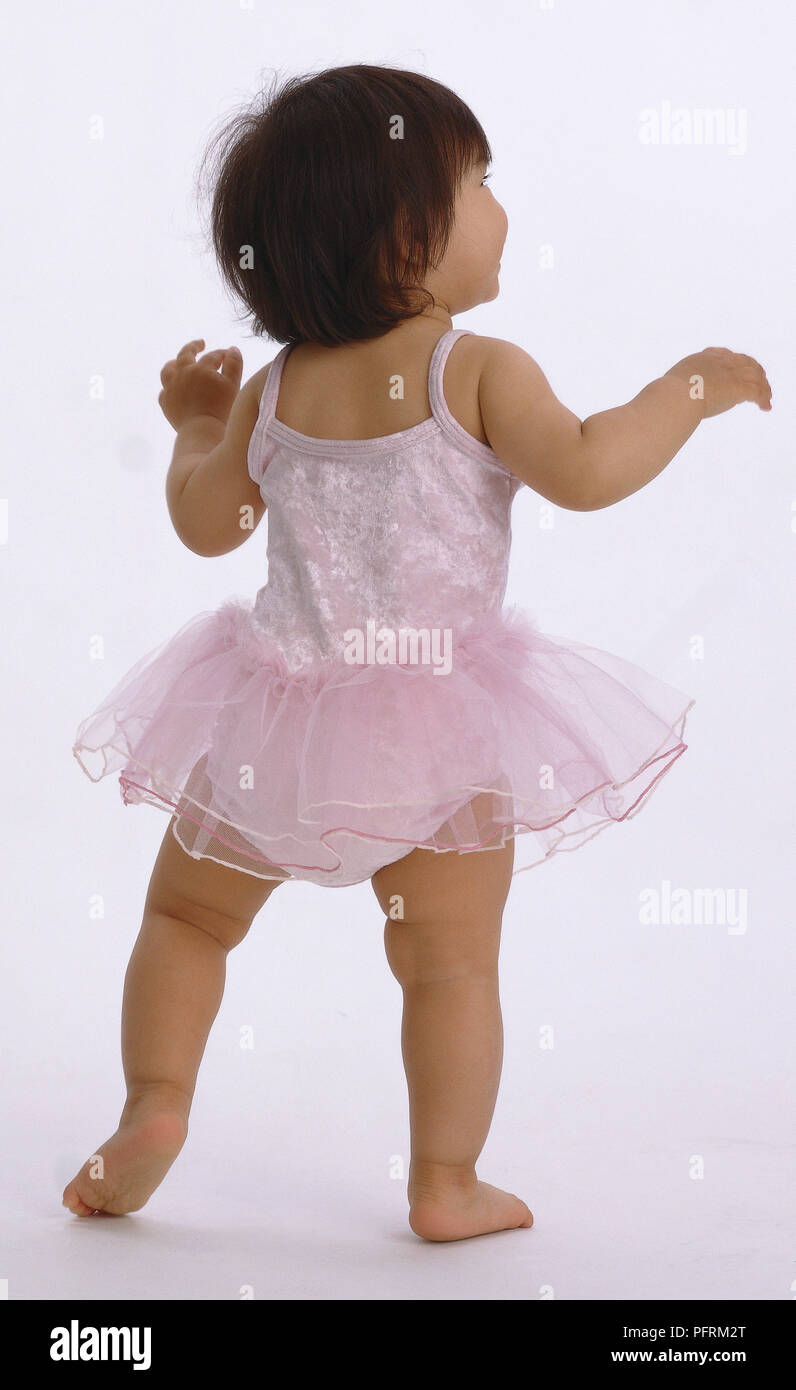 Rear view of barefoot toddler wearing pink ballerina tutu Stock Photo -  Alamy