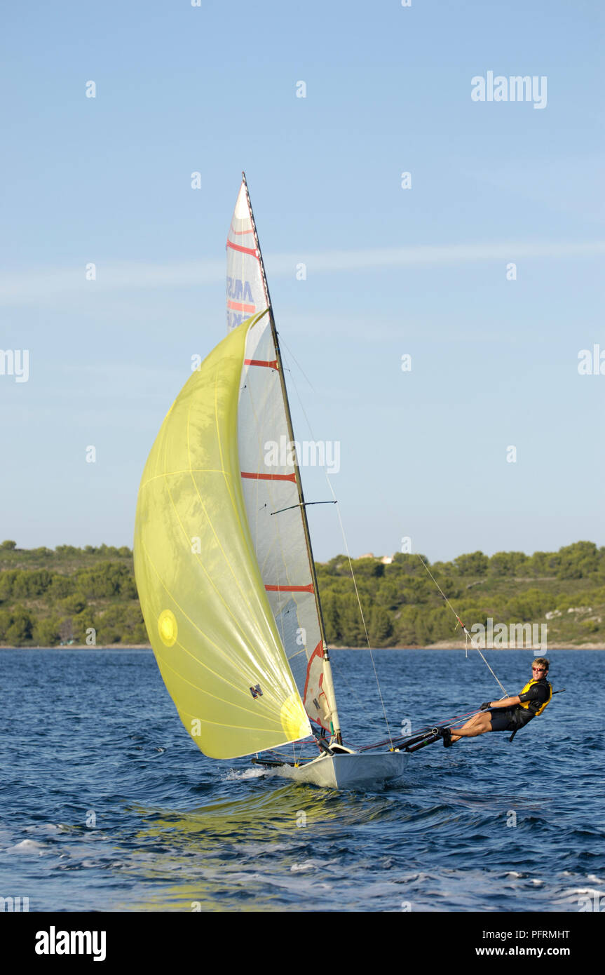 Spain, Minorca, young man sailing dinghy Stock Photo Alamy