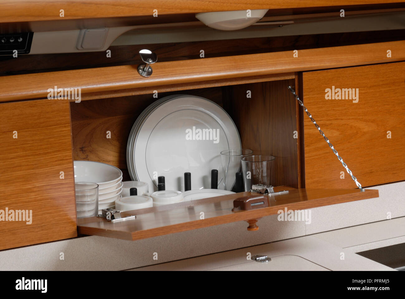 Cupboard in yacht's galley Stock Photo