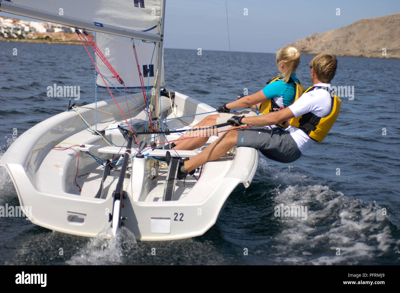 Spain, Minorca, young woman and man sailing dinghy Stock Photo Alamy