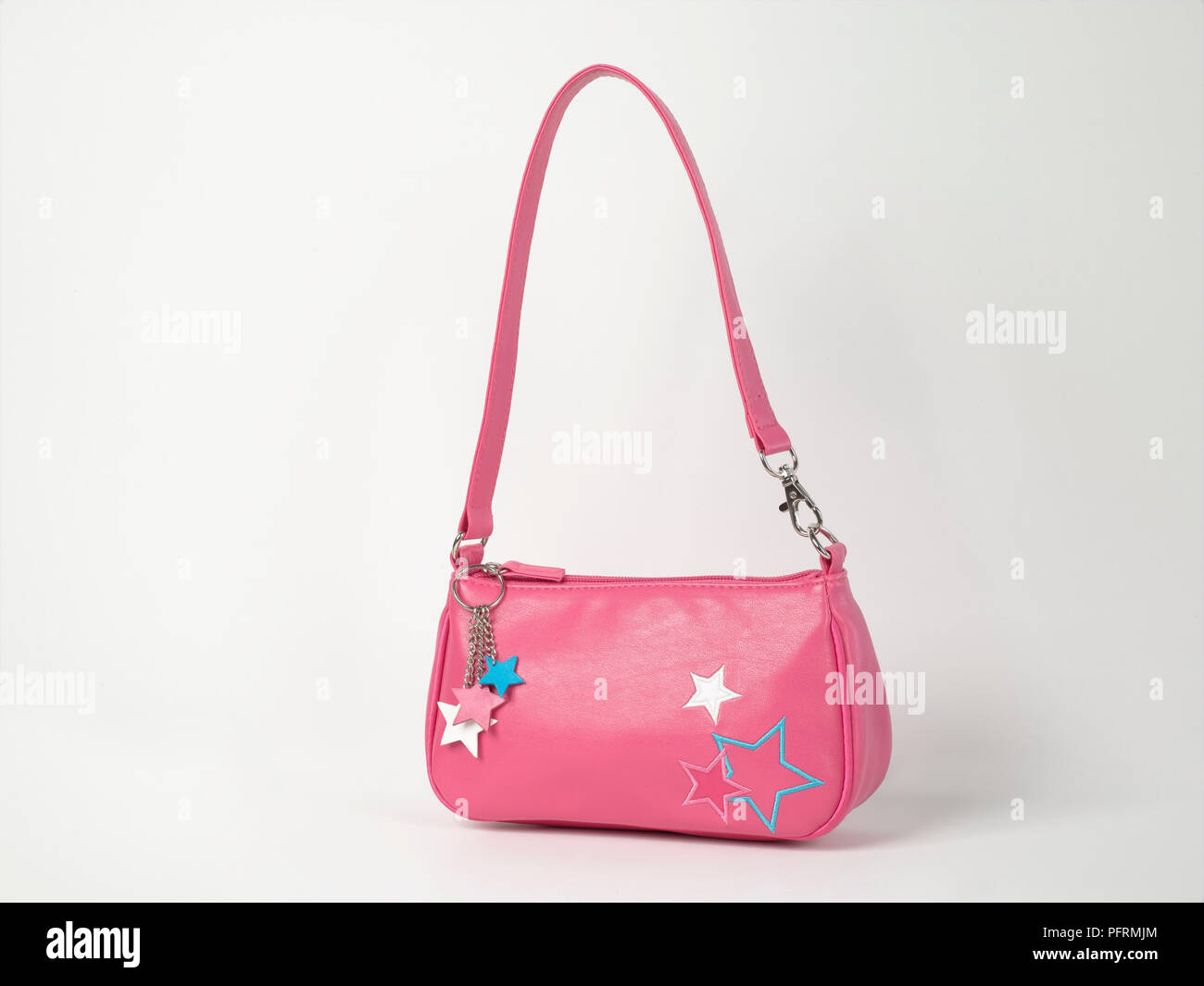 Small pink handbag with embroidered star motif and star key ring on zipper Stock Photo