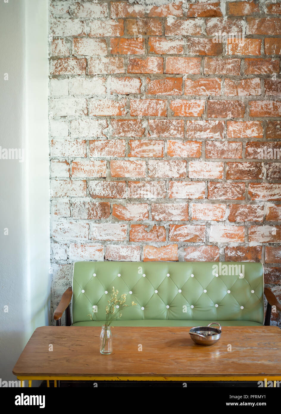Loft Interior Cafe With Green Vintage Leather Sofa Flower In
