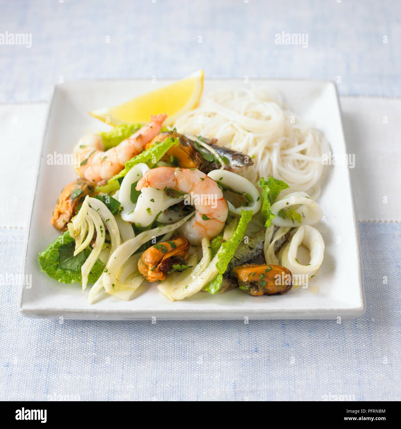 Seafood and fennel salad with noodles and anchovy dressing on white
