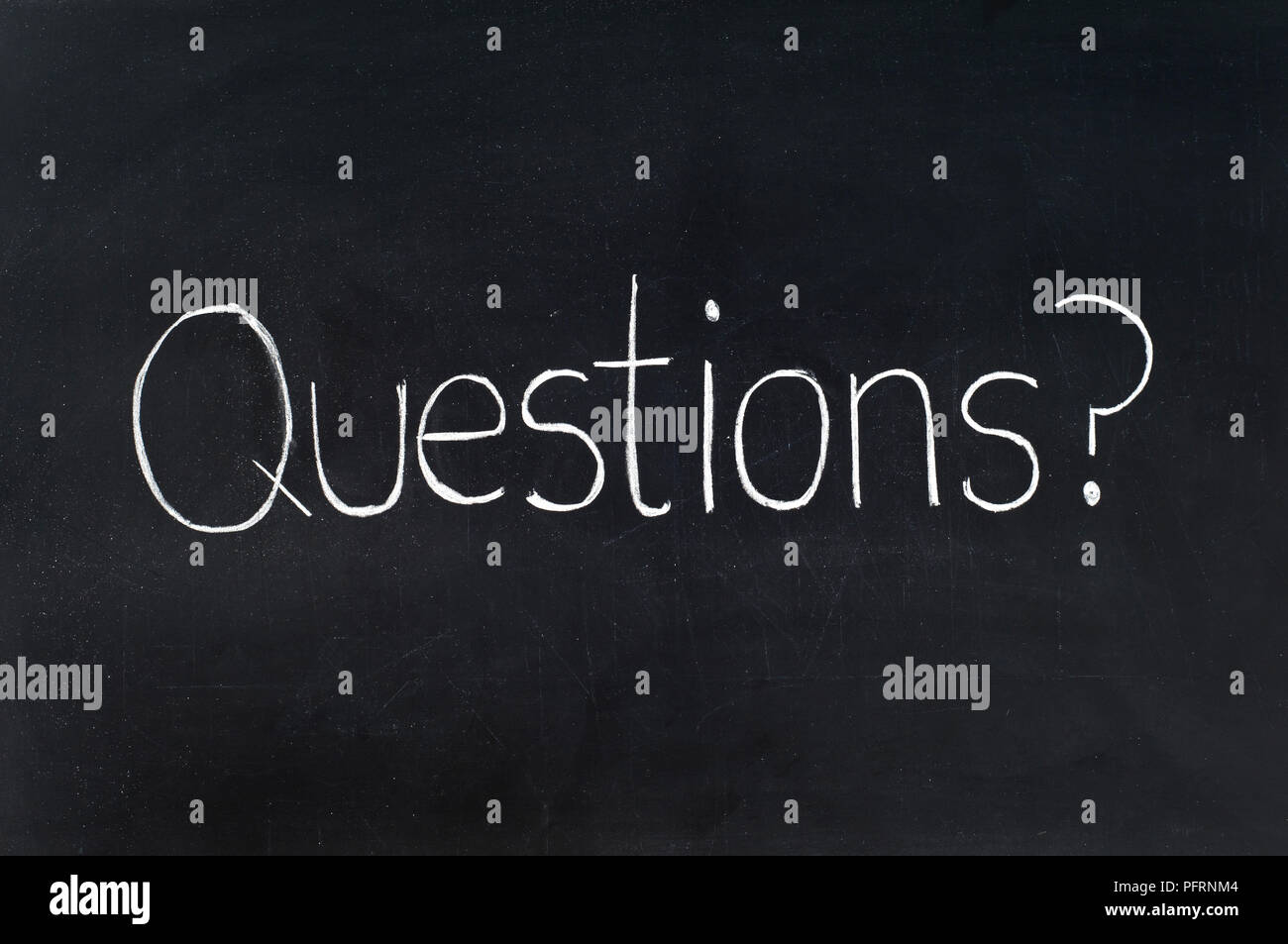 The word 'questions' written on a blackboard Stock Photo