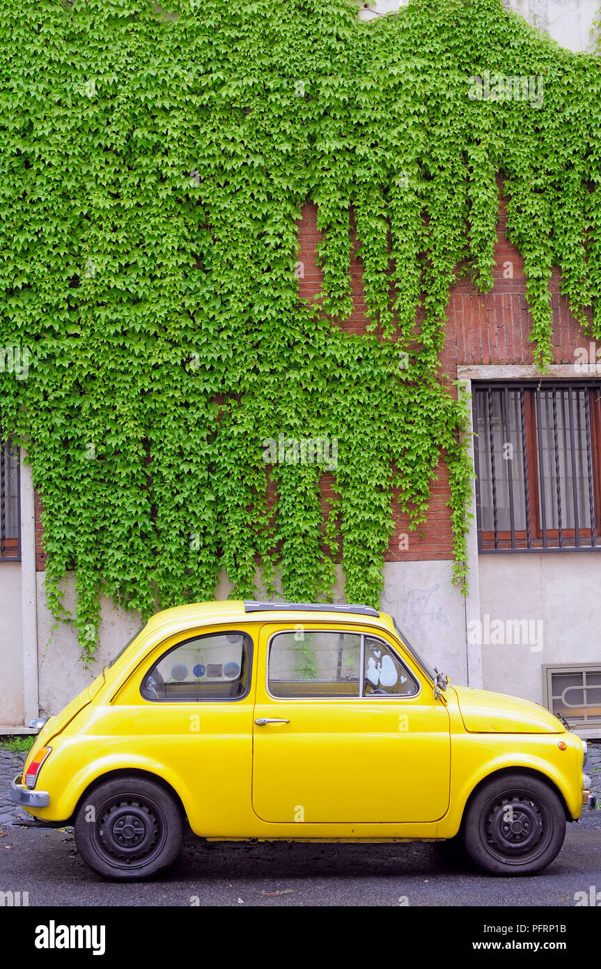 Italy, Rome, yellow Fiat 500 parked in street Stock Photo