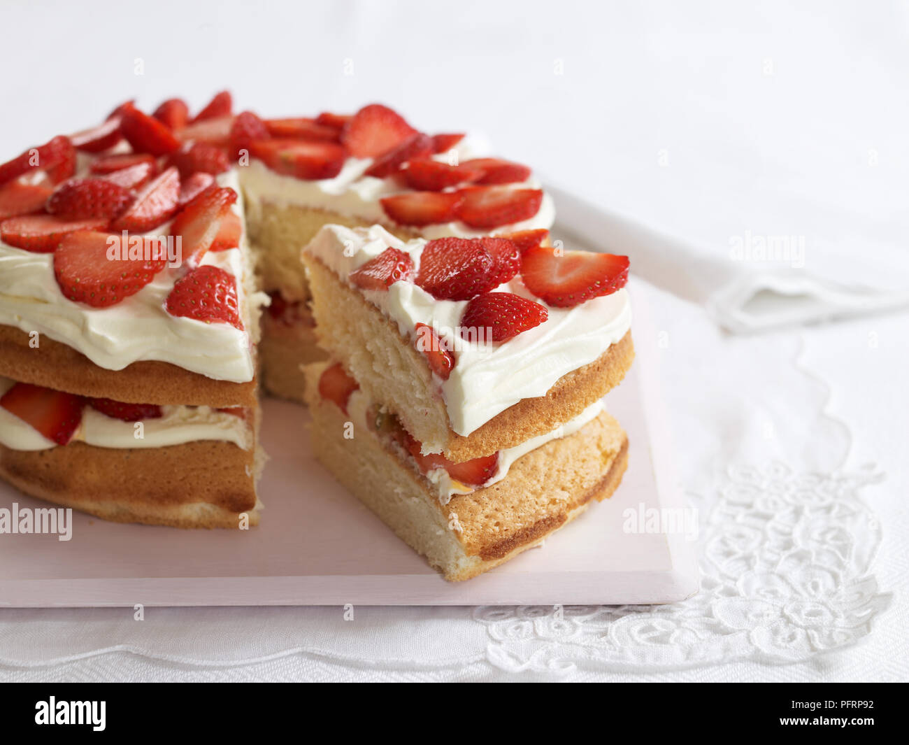 Wimbledon Cake with sponge, cream and strawberries Stock Photo