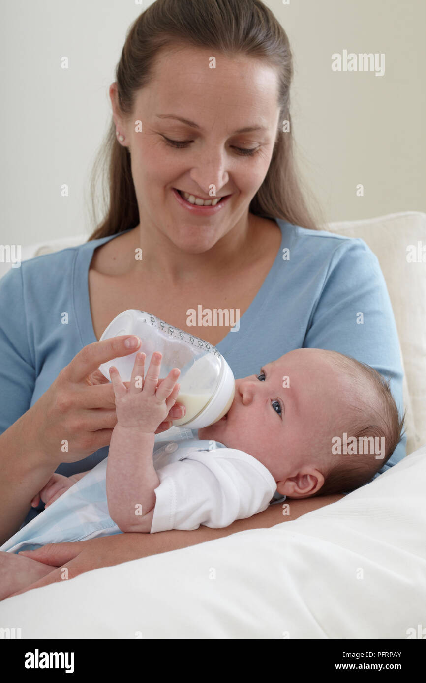 Woman feeding cheap baby